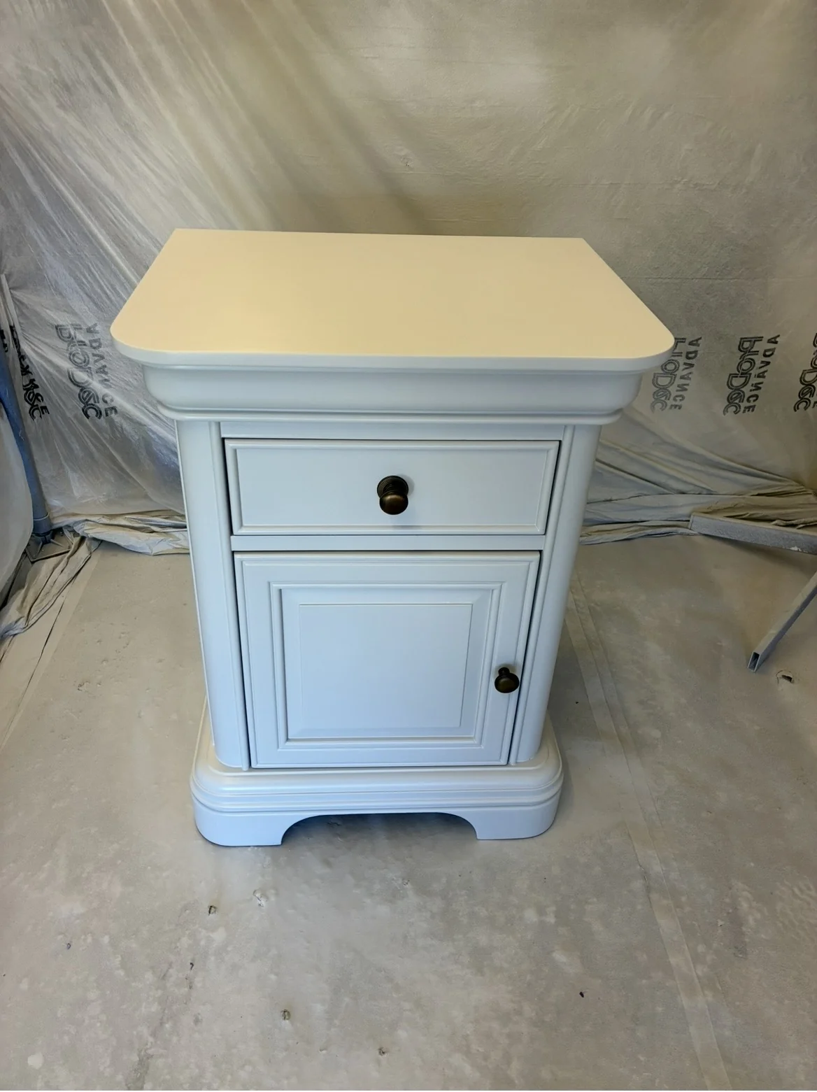 White bedside cabinet after spraying